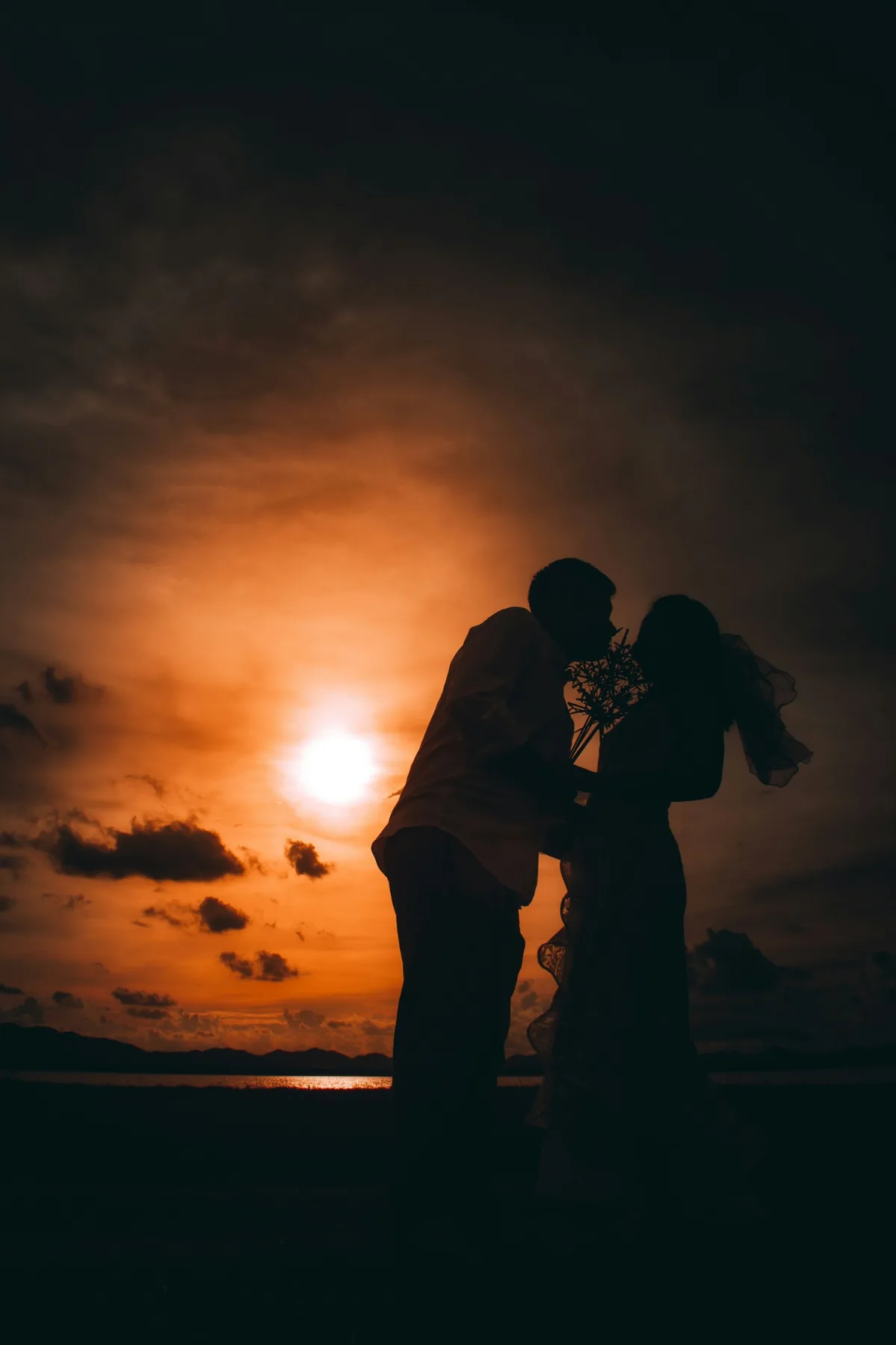 Pre-wedding couple silhouette at sunset